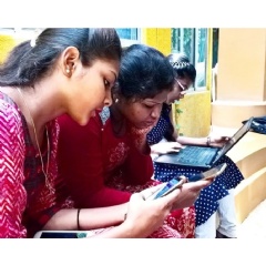 Three young women practice their life skills through Passport to Success Traveler during the project pilot in India.