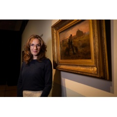 Curator Lisa Smit in front of the painting Peasant Spreading Manure by Jean-François Millet. Photographer: Elvin Boer