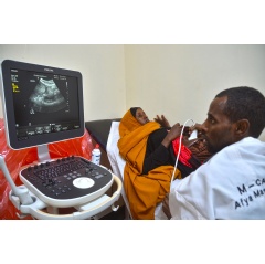 A Community Life Center nurse is doing a pregnancy scan on a Mandera woman with Philips ultrasound technology